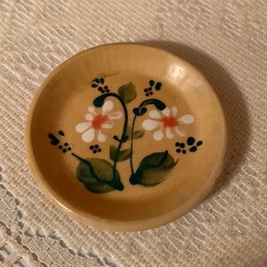 Small hand painted earth ware plate with floral design